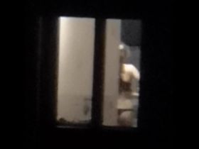 Сосед подсматривает в окно и снимает молодую девушку в чёрных трусиках